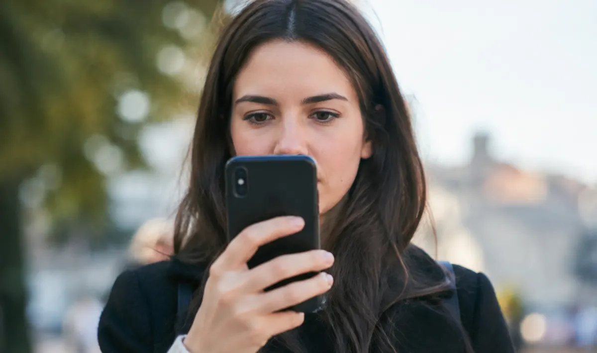 Personne tenant telephone mobile vertical devant visage